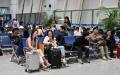 2025年4月12日，旅客们在中国浙江的义乌机场候机。（图片来源：ADEK BERRY/AFP via Getty Images）