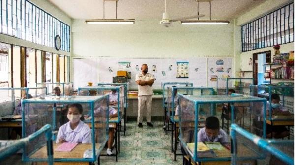 学生上课的情景:除了保持社交距离外,每个课桌上都有个塑料框。(Lauren DeCicca/Getty Images)