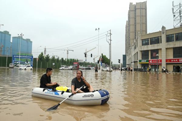 7月23日,洪水中的郑州市民(NOEL CELIS/AFP via Getty Images)