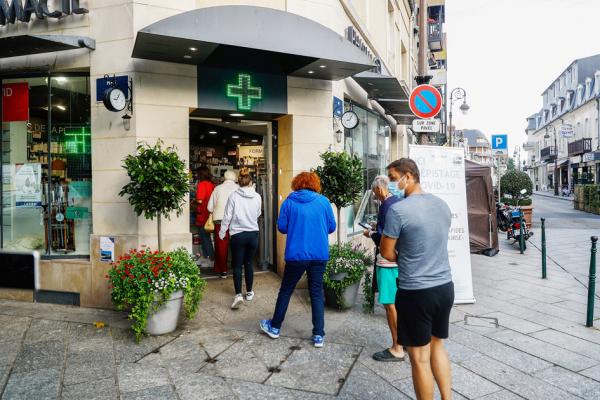 8月4日,在法国北部城市多维尔(Deauville)的一家药店门口,顾客排队进行核酸检测(PCR)。(Sameer Al-DOUMY/AFP via Getty Images)
