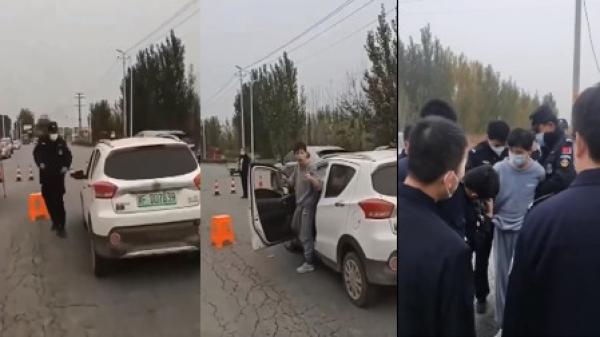 河北保定疫情封控中的一名男子手持菜刀声明儿子急需奶粉,驾车闯防疫关卡去买奶粉被抓。(图片来源:视频截图)