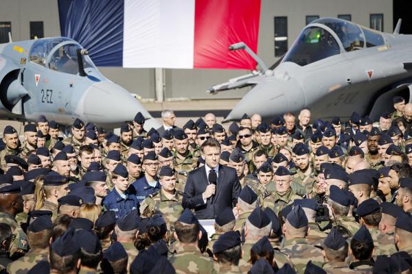 2025年3月18日,法国总统马克龙(中)在访问法国东北部吕克瑟伊-圣索沃尔空军基地时,在幻影2000战斗机(左)和阵风战斗机(右)前发表演讲。(LUDOVIC MARIN/POOL/AFP via Getty Images)