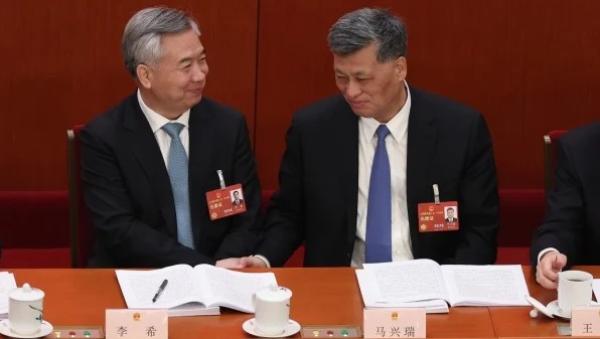 2023年3月5日,中共十四届全国人大一次会议在北京开幕,中共中纪委书记李希(左)与时任新疆党委书记马兴瑞(右)出席开幕式。(图片来源:Lintao Zhang/Getty Images)