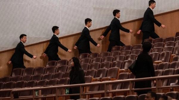 2026年3月12日,中共全国人民代表大会闭幕式开始前,在北京人民大会堂的安保人员走向各自岗位。(图片来源:Kevin Frayer/Getty Images)